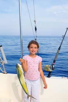 child girl fishing in boat with mahi mahi dorado fish catch with rod and trolling reels