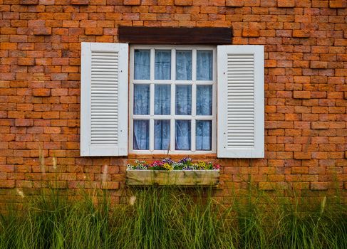 Attached to a white brick wall brown.