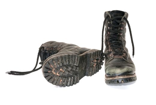 Pair worn army boots it is isolated on a white background.