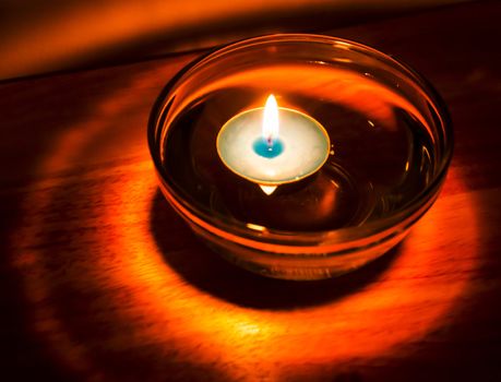 Aromatherapy candle floating in oil