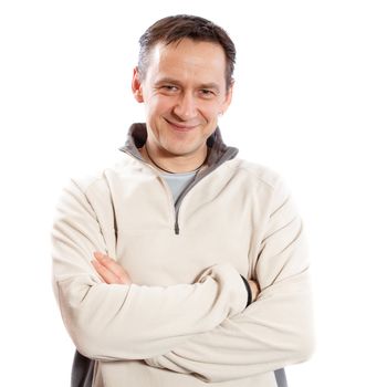 Casual man looking at camera with arms crossed on white background