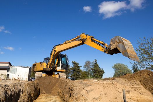 excavator digging sewer trenche in construction site
