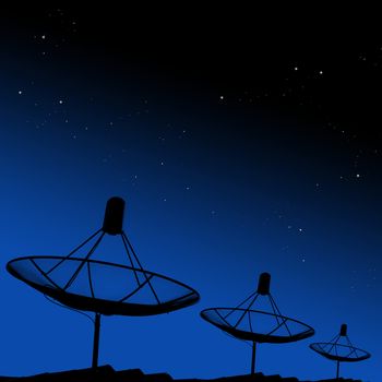 Satellite dishes on rooftop with night sky background