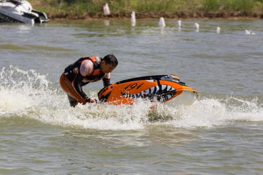 SARABURI THAILAND-JANUARY 20: Boonlue Korbangyang in action during show Freestyle the Jet ski  stunt action  on Jan 20, 2013 in SARABURI,Thailand.