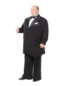 Elegant very fat man in a tuxedo and bow tie shows thumb-up, on white background