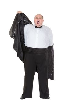 Very overweight elegant fat man yawning after a night out as he strips off his dinner jacket, studio portrait on white