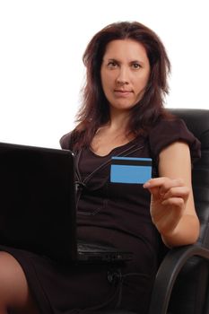 Serious woman holding credit card with laptop over white, focus on woman