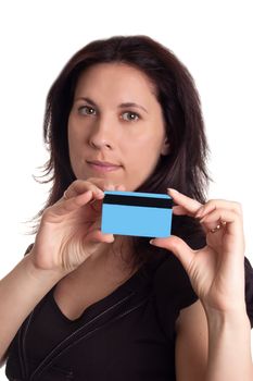 Serious woman holding blue credit card isolated on white