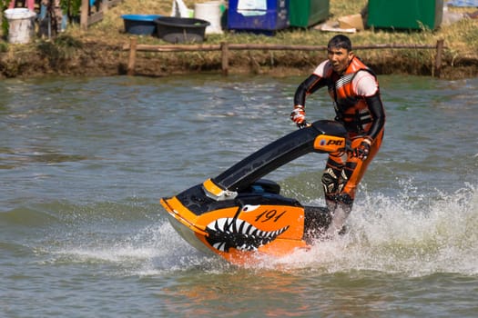 SARABURI THAILAND-JANUARY 20: Boonlue Korbangyang in action during show Freestyle the Jet ski  stunt action  on Jan 20, 2013 in SARABURI,Thailand.