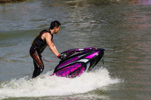 SARABURI THAILAND-JANUARY 20: Somchai Sae-Tang in action during show Freestyle the Jet ski  stunt action  on Jan 20, 2013 in SARABURI,Thailand.