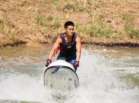 SARABURI THAILAND-JANUARY 20: Veerapong Maneechom in action during show Freestyle the Jet ski  stunt action  on Jan 20, 2013 in SARABURI,Thailand.