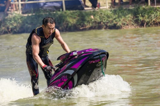 SARABURI THAILAND-JANUARY 20: Somchai Sae-Tang in action during show Freestyle the Jet ski  stunt action  on Jan 20, 2013 in SARABURI,Thailand.