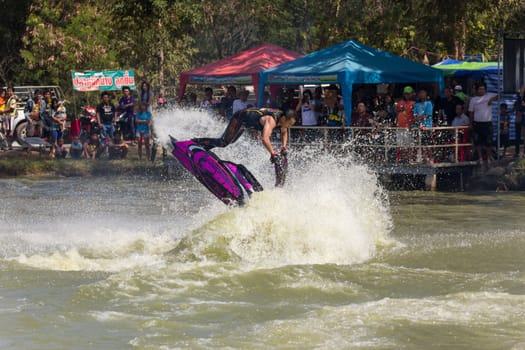 SARABURI THAILAND-JANUARY 20: Somchai Sae-Tang in action during show Freestyle the Jet ski  stunt action  on Jan 20, 2013 in SARABURI,Thailand.