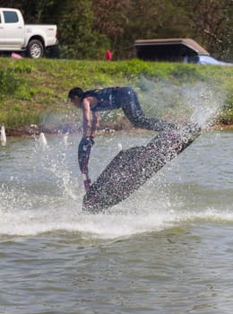 SARABURI THAILAND-JANUARY 20: Somchai Sae-Tang in action during show Freestyle the Jet ski  stunt action  on Jan 20, 2013 in SARABURI,Thailand.