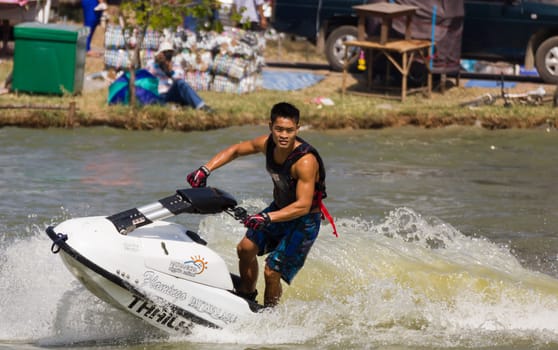 SARABURI THAILAND-JANUARY 20: Veerapong Maneechom in action during show Freestyle the Jet ski  stunt action  on Jan 20, 2013 in SARABURI,Thailand.
