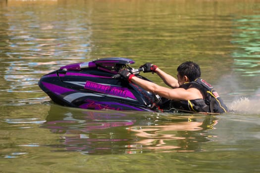 SARABURI THAILAND-JANUARY 20: Somchai Sae-Tang in action during show Freestyle the Jet ski  stunt action  on Jan 20, 2013 in SARABURI,Thailand.