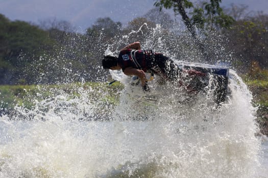 SARABURI THAILAND-JANUARY 20: Sonswut Rappasubpisan in action during show Freestyle the Jet ski  stunt action  on Jan 20, 2013 in SARABURI,Thailand.