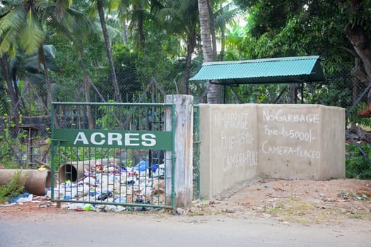 Horizontal landscape of a scene in Goa, India. Typifies a cultural attitude towards littering in urban and rural areas.