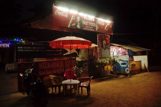 Typical fast food and refreshment shack on the roadside at Goa, with parked scooter plus table and chairs