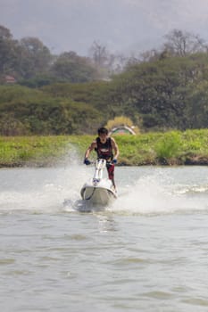 SARABURI THAILAND-JANUARY 20: Sonswut Rappasubpisan in action during show Freestyle the Jet ski  stunt action  on Jan 20, 2013 in SARABURI,Thailand.