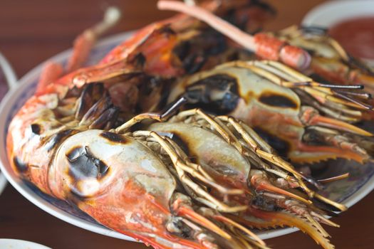 Grilled shrimp are placed on a plate