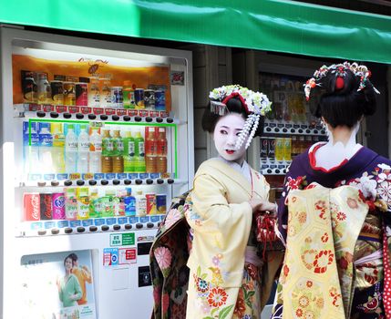 KYOTO, JAPAN - OCT 21 2012: Japanese ladies in traditional dress  on a street leading to Kiyomizu Temple on October 21 2012. Kiyomizu is a famous temple in Kyoto built in year 778.
