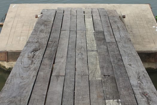 Wooden bridge spanning the river to the pontoon