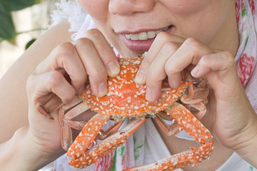 young woman eating a delicious steamed crabs
