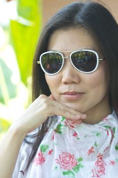 Closeup picture of a young woman wearing dark glasses