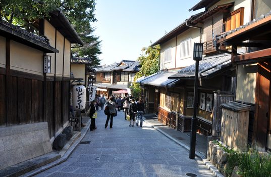 KYOTO, JAPAN - OCT 21 2012: Tourists walk on a street leading to Kiyomizu Temple on October 21 2012. Kiyomizu is a famous temple in Kyoto built in year 778.