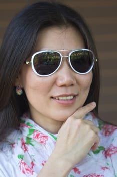Closeup picture of a young woman wearing dark glasses