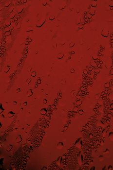 Background with water drops in red color