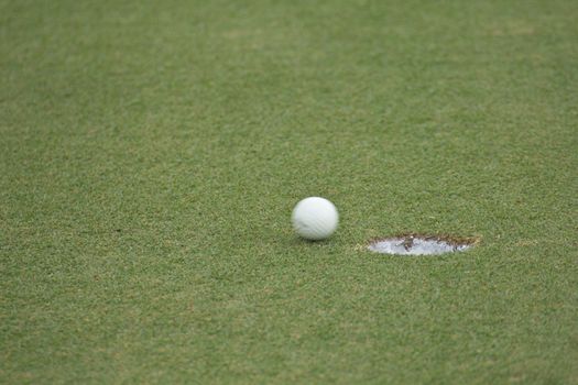 Golf ball very close to the hole