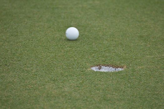 Golf ball very close to the hole