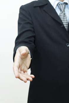 Business man with hand extended to handshake 