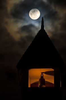 Moon over bell tower on cloudy days