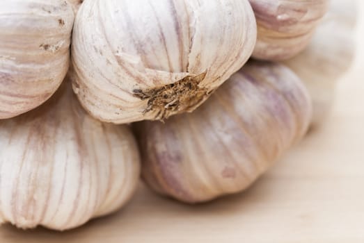 Macro image of garlic against wooden background.