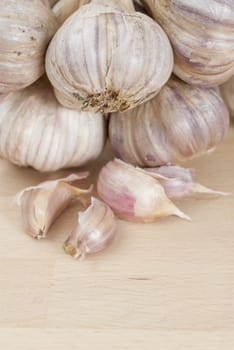Bunch of garlic on wooden kitchen work surface.