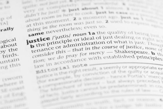 Macro image of dictionary word: Justice.