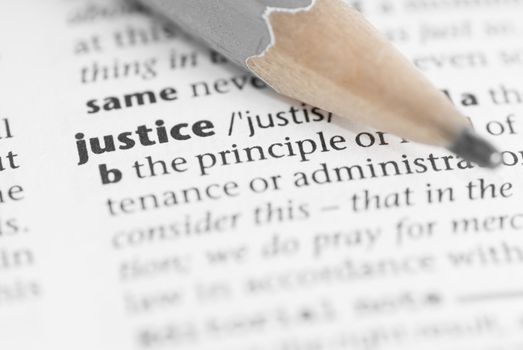 Macro image of dictionary word: Justice, and pencil.