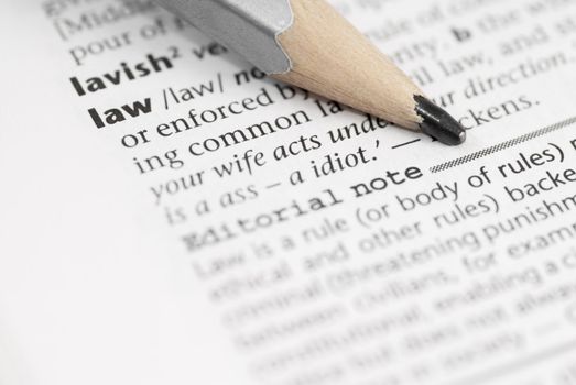 Macro image of dictionary word: Law, and pencil.