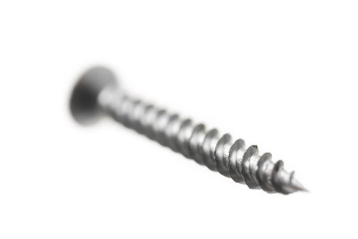 One new metal screw on white background.