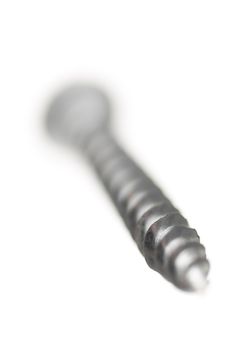 One new metal screw on white background.