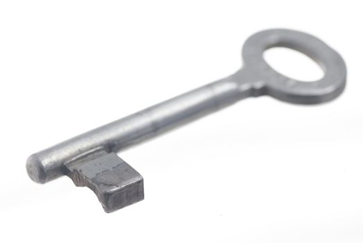 One old house key, white background.