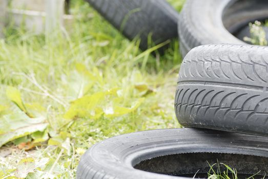 Used, dumped car tyres. Copy space.