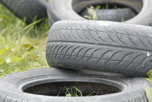 Used, dumped car tyres. Copy space.