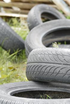 Used, dumped car tyres. Copy space.