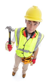 Above perspective view of a young apprentice builder wearing protective work gear and holding a hammer. White background.