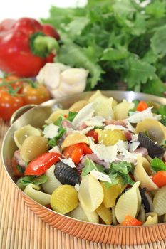 a noodle dish with vegetables and ham strips