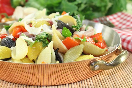 a noodle dish with vegetables and ham strips